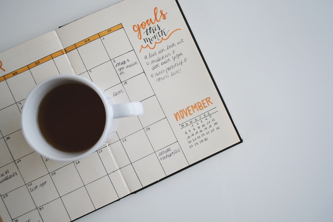Open calendar and notebook on a desk representing the timeline of persistent pain