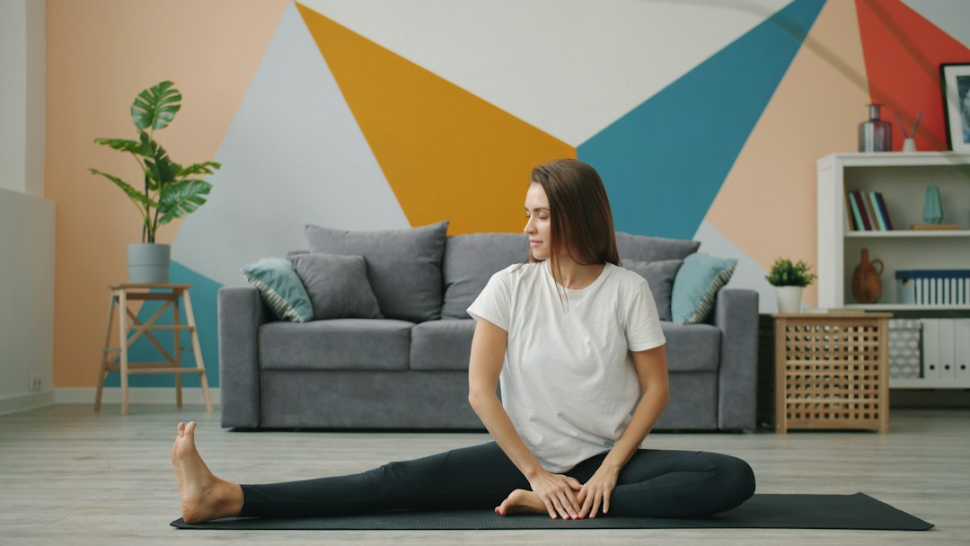 Adult stretching at home while noting how activity affects pain