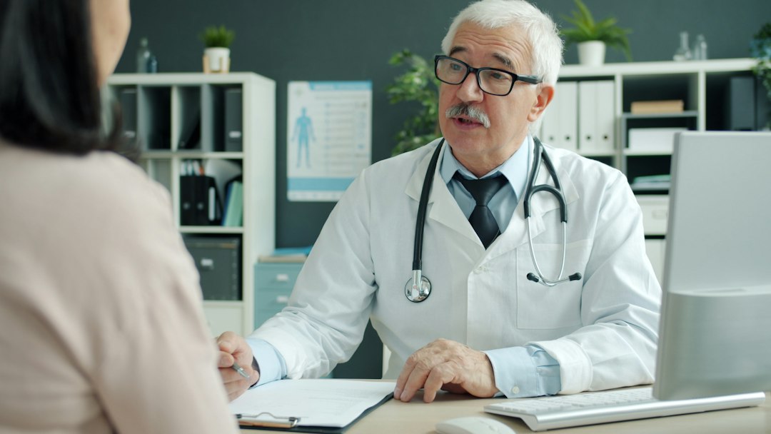 Healthcare provider discussing medication details with a patient during a follow-up visit