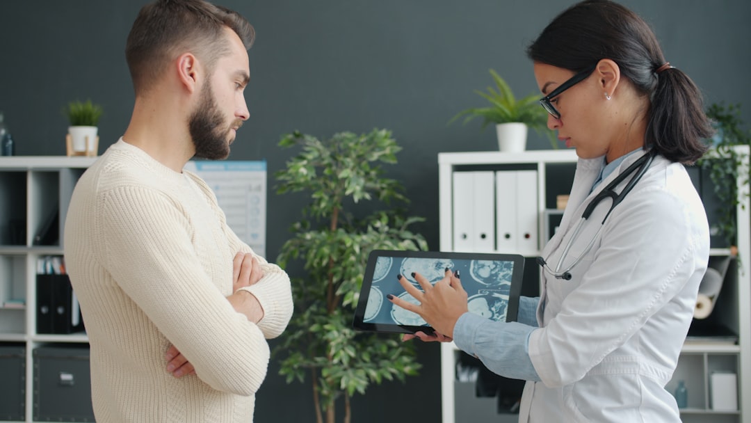 Clinician and patient reviewing medical information during a consultation
